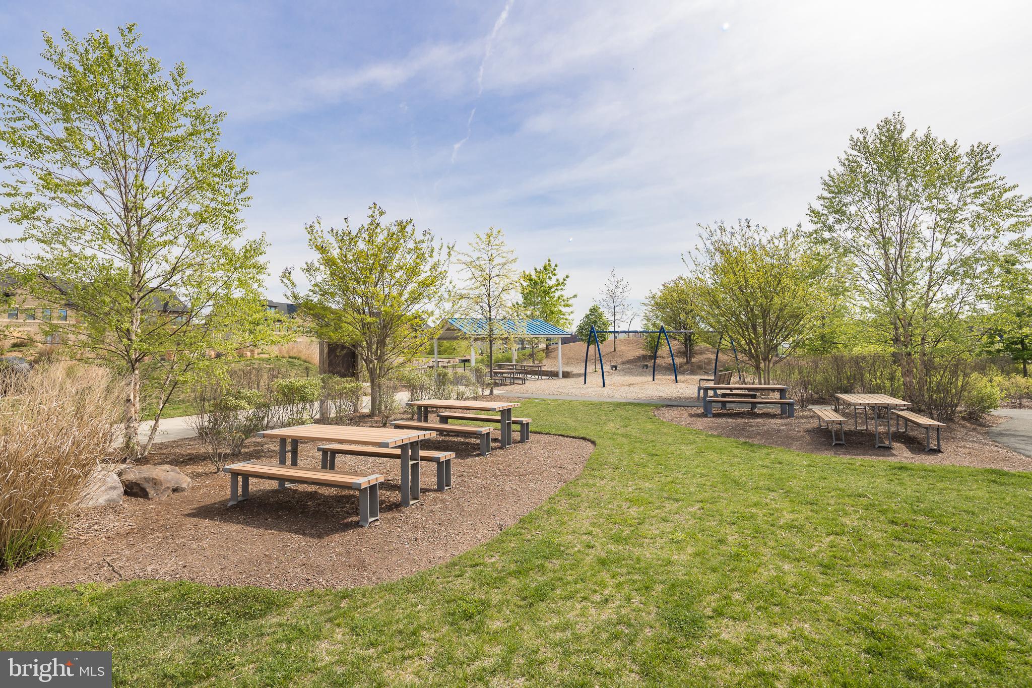 22355 Exe Square Ashburn, VA 20148 - Photo 57 of 65 a view of a swimming pool with a bench and trees around