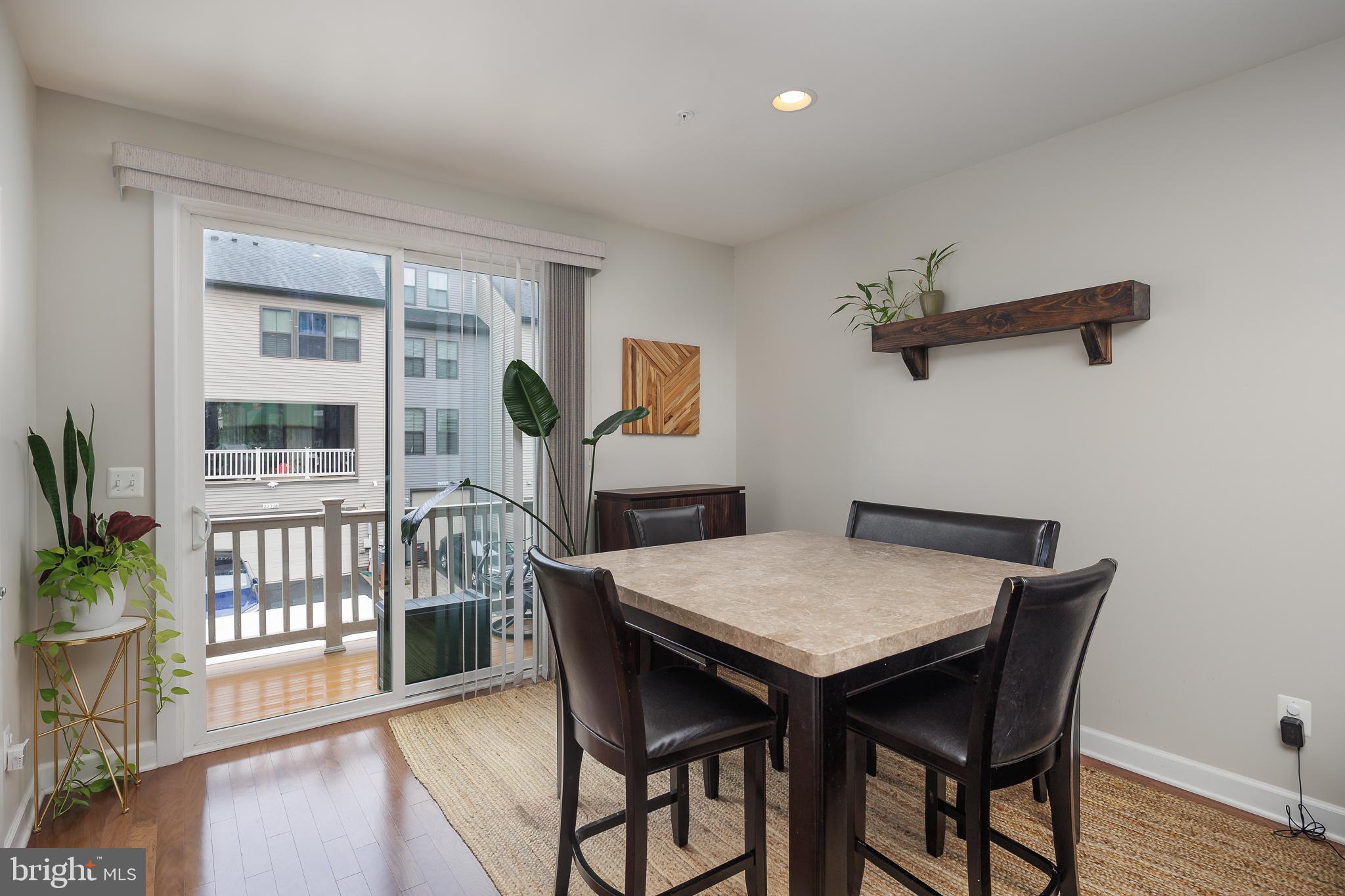 22355 Exe Square Ashburn, VA 20148 - Photo 6 of 65 a view of a dining room with furniture window and wooden floor