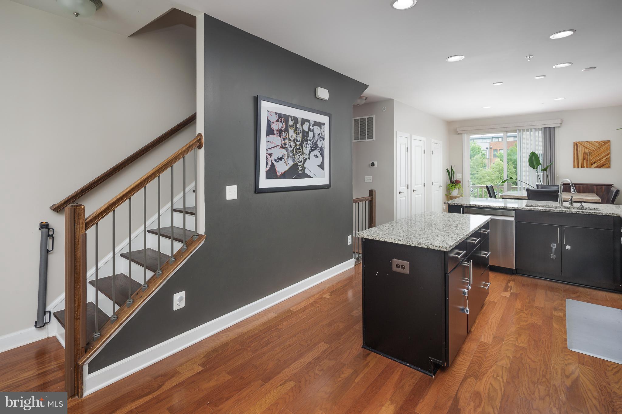 22355 Exe Square Ashburn, VA 20148 - Photo 9 of 65 a kitchen with stainless steel appliances granite countertop a refrigerator a sink dishwasher a stove and white countertops with wooden floor