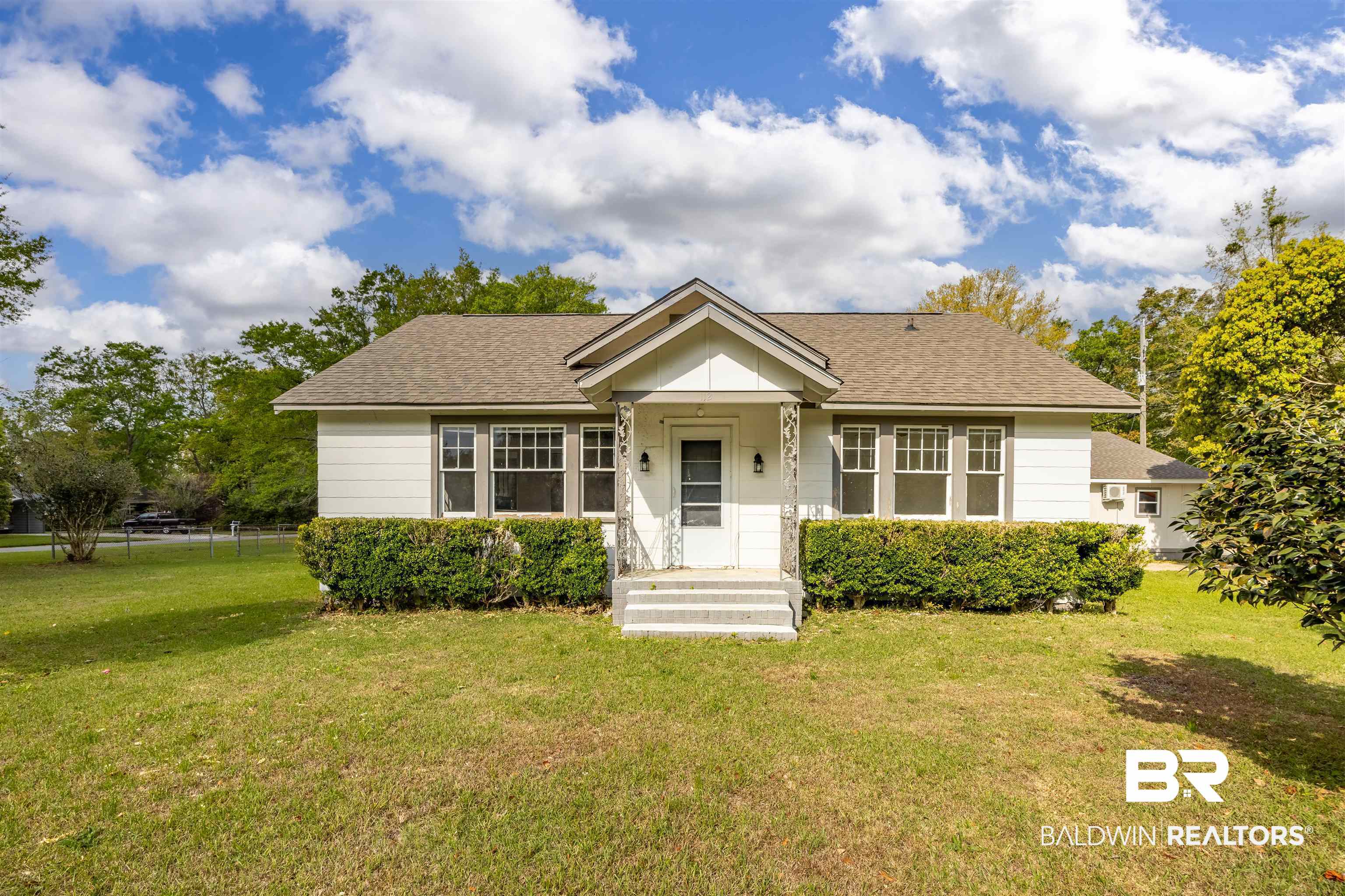 112 South Juniper Street Foley, AL 36535 - Photo 2 of 64 Bungalow featuring a shingled roof, a front yard, and a porch