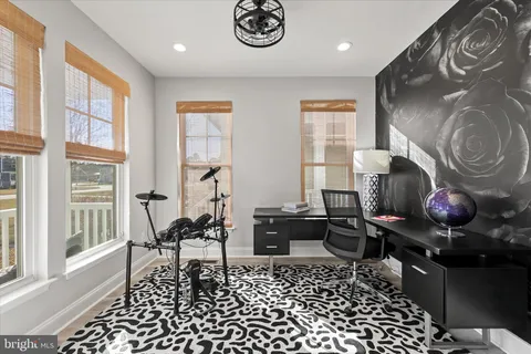 a kitchen with stainless steel appliances granite countertop a stove a dining table and chairs with wooden floor