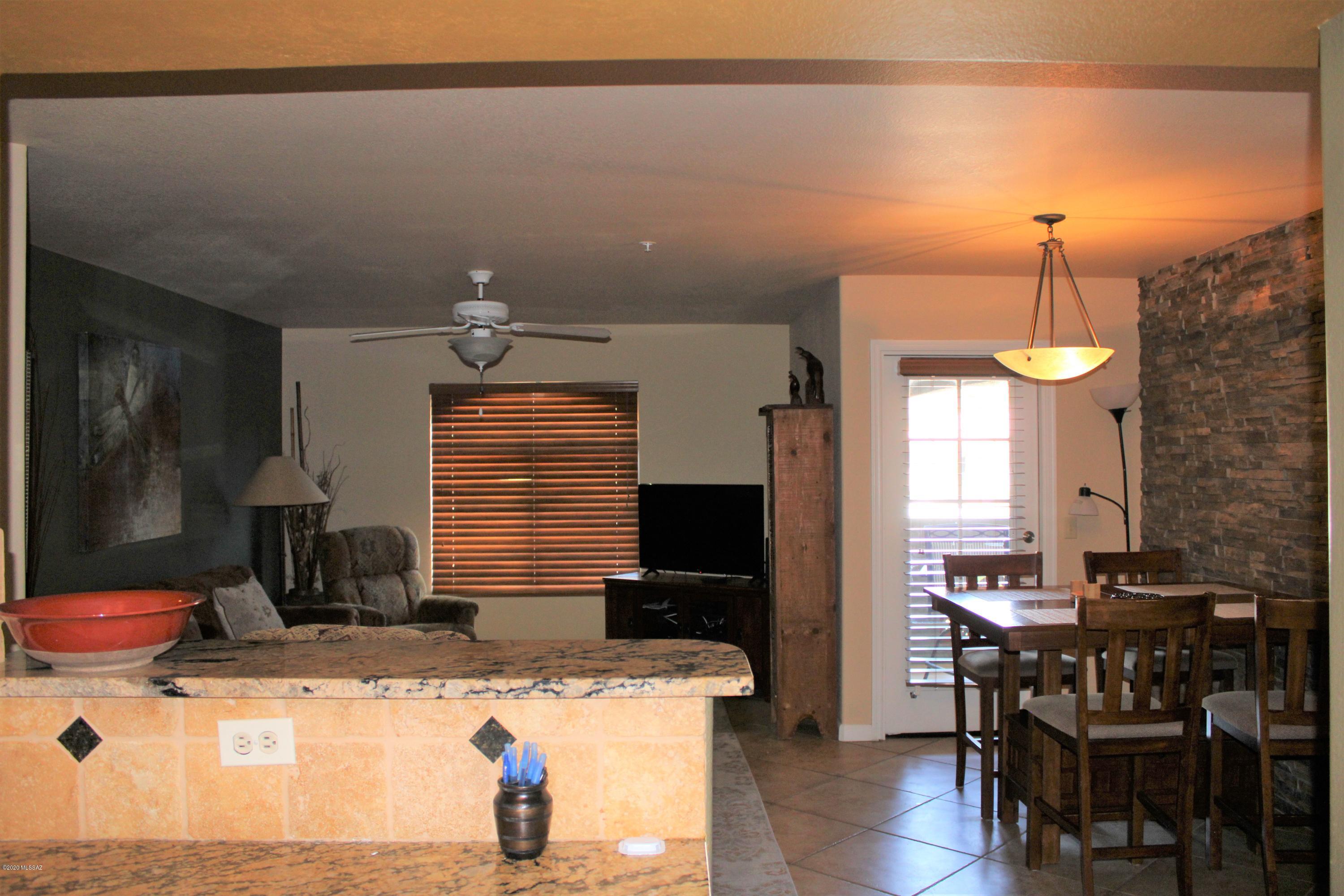 5751 North Kolb Road, Unit 36203 Tucson, AZ 85750 - Photo 9 of 25 a kitchen view of a dining table chairs and chandelier