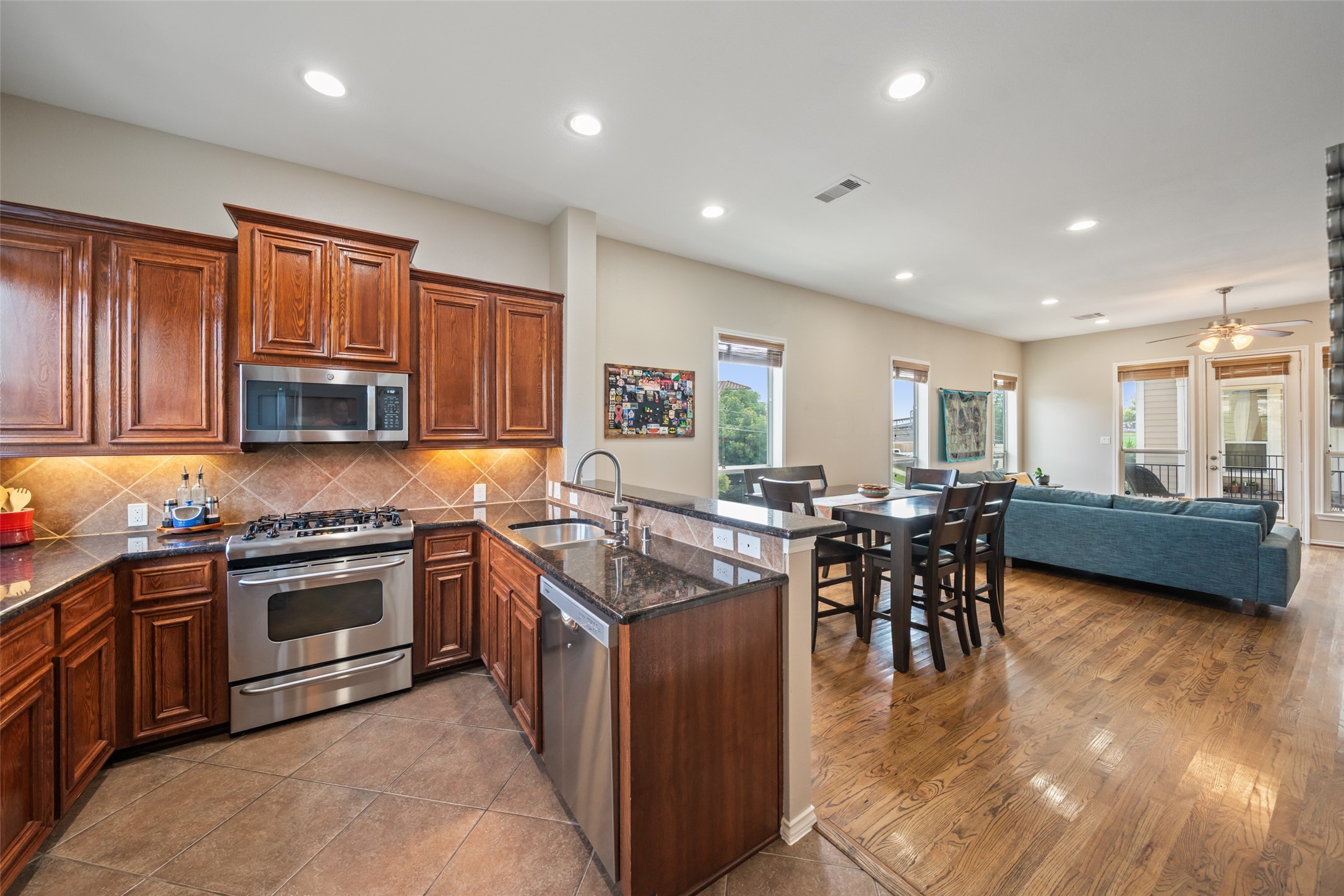 2613 Link Road Houston, TX 77009 - Photo 3 of 28 The kitchen is adjacent to the living room with high ceilings, plentiful Mahogany cabinets, and abundant granite counter space, with all stainless steel appliances.