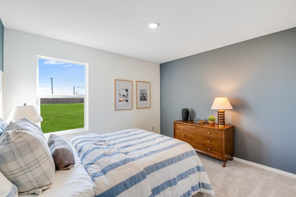 1280 Balsam Road Wilmer, TX 75172 - Photo 19 of 22 a bedroom with a bed and a lamp