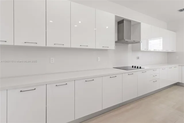 a kitchen with stainless steel appliances kitchen island granite countertop a sink and cabinets