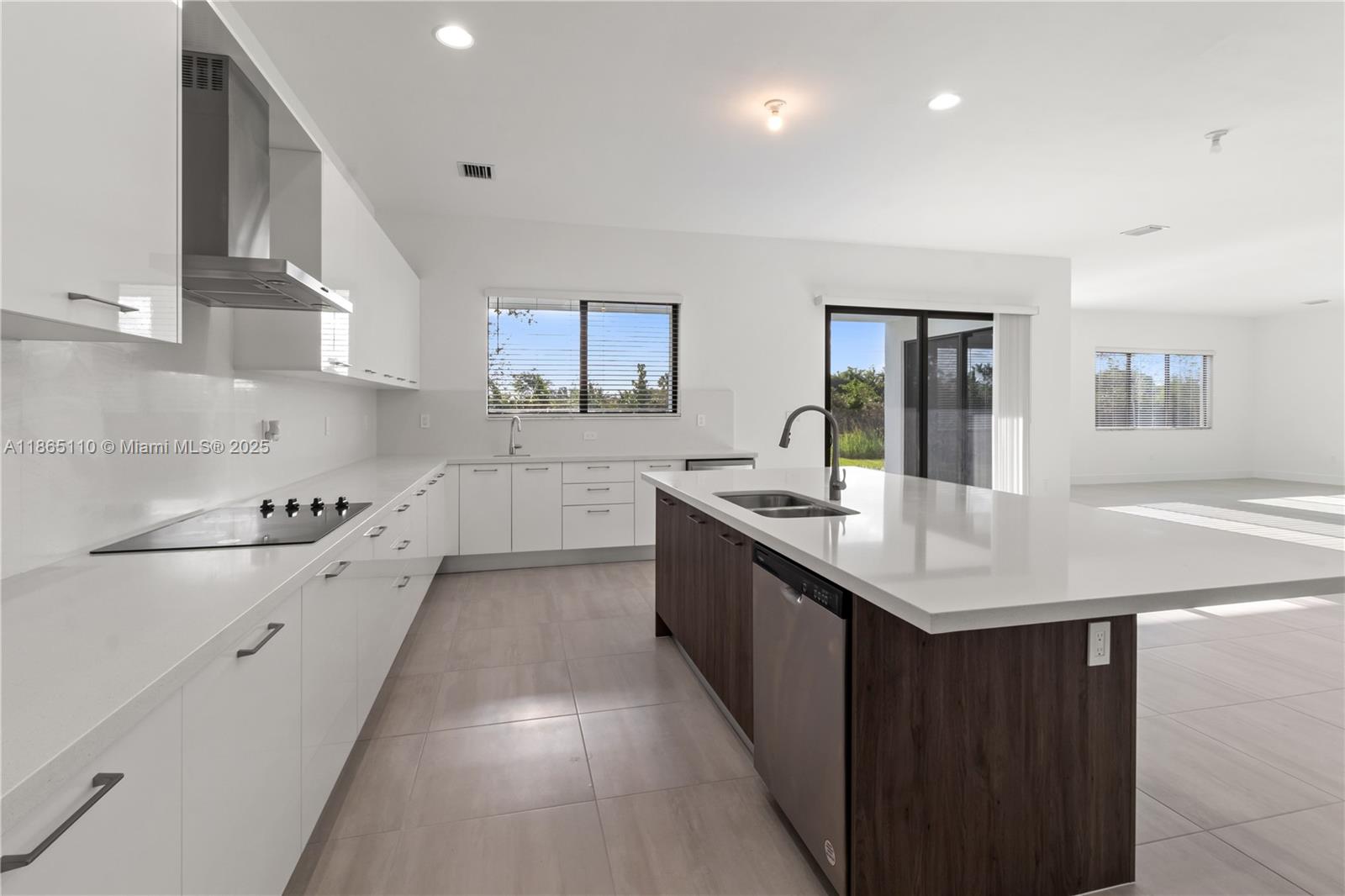 2391 Southwest 123rd Terrace Davie, FL 33325 - Photo 12 of 39 a kitchen with granite countertop a sink stove and cabinets