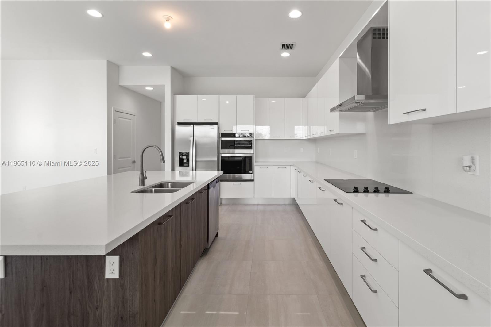2391 Southwest 123rd Terrace Davie, FL 33325 - Photo 13 of 39 a kitchen with stainless steel appliances kitchen island granite countertop a sink and cabinets