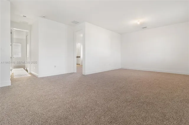 a view of staircase with white walls