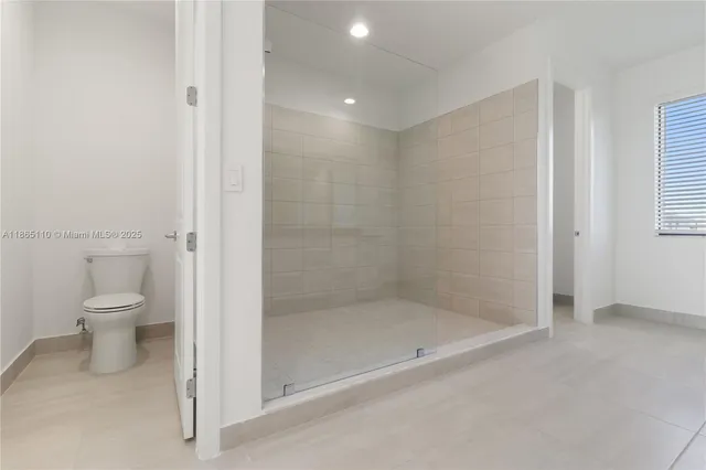 a bathroom with a shower and a toilet