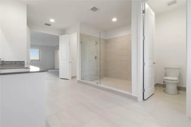 an empty room with windows and closet