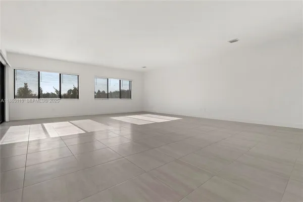 a view of empty room with windows