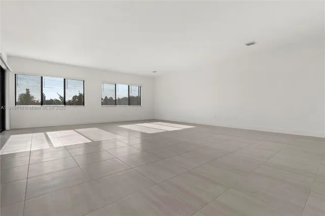 a view of a living room hardwood floor and a kitchen