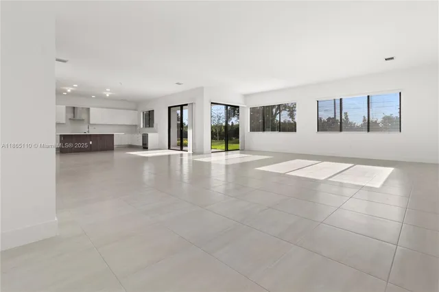 an empty room with fireplace and windows