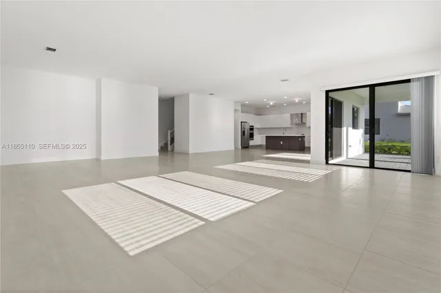 an empty room with fireplace and windows