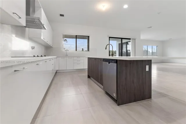 a kitchen with white cabinets and white appliances