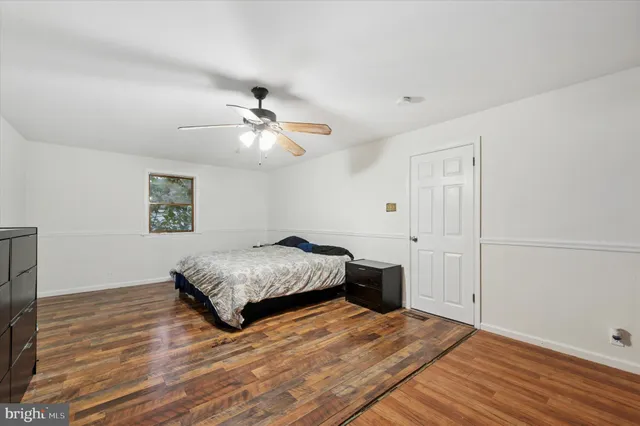 a spacious bedroom with a bed and a chandelier