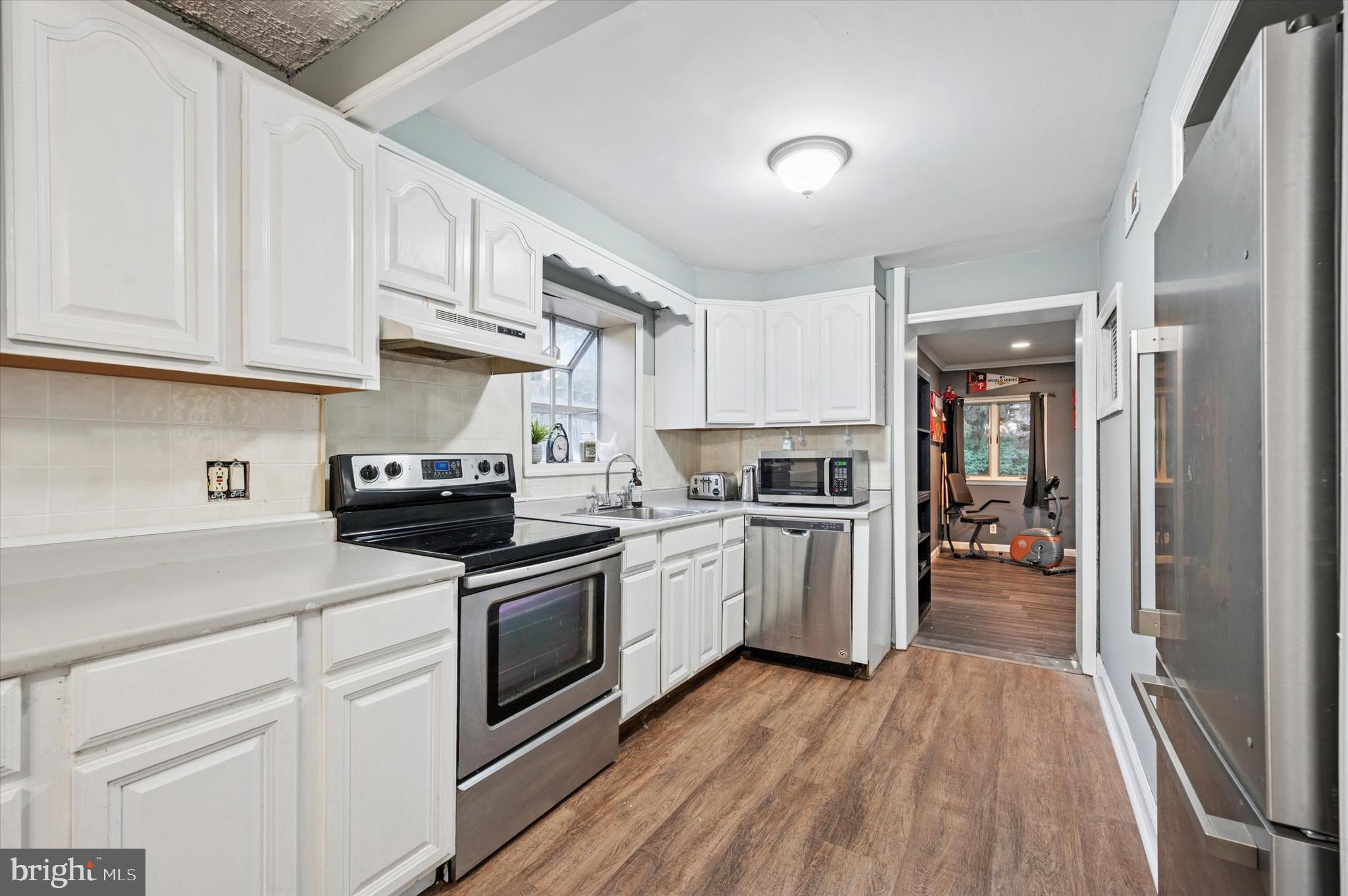 2379 Mole Road Secane, PA 19018 - Photo 10 of 26 a kitchen with white cabinets and stainless steel appliances