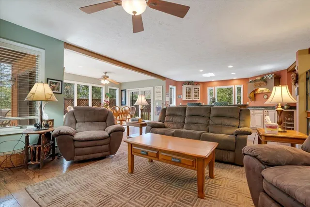 a bathroom with a granite countertop sink a mirror and a bathtub