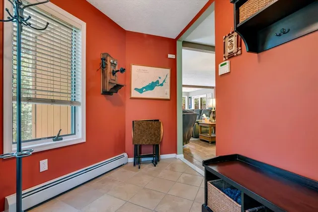 a open kitchen with stainless steel appliances granite countertop a stove top oven a sink a dining table and chairs with wooden floor