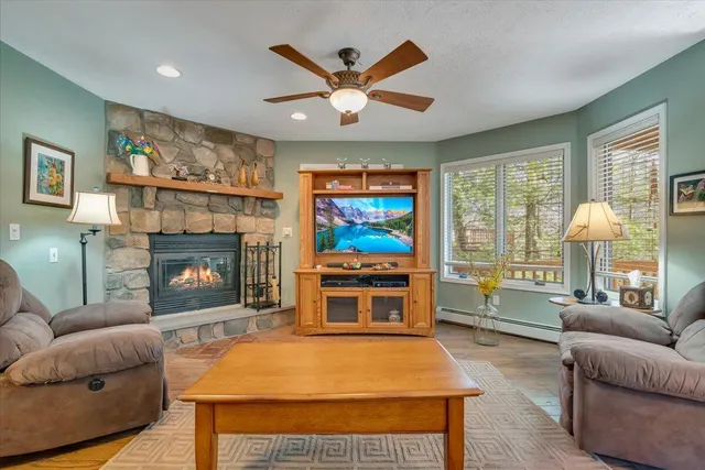 a bedroom with a bed a window and flat screen tv