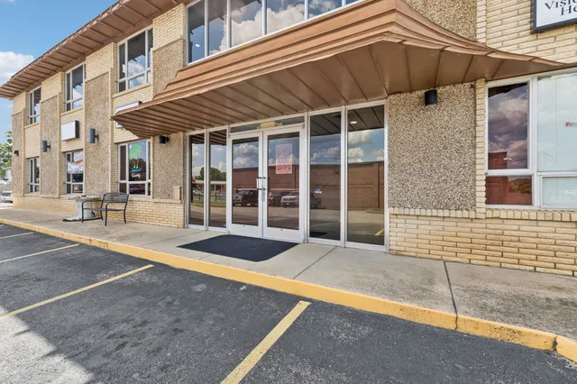 a view of a house with a small backyard