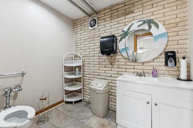 a bathroom with a toilet and a shower curtain