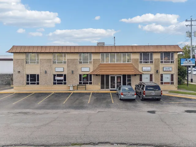 a view of building with car parked