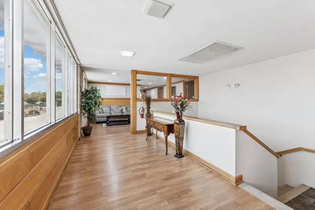 a view of a room with wooden floor and furniture