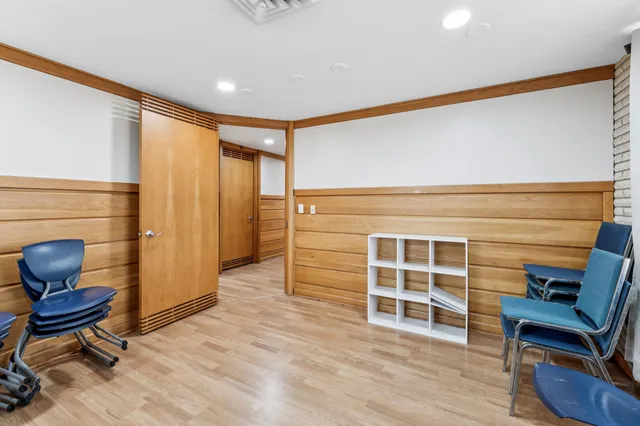 a view of workspace with wooden floor and windows