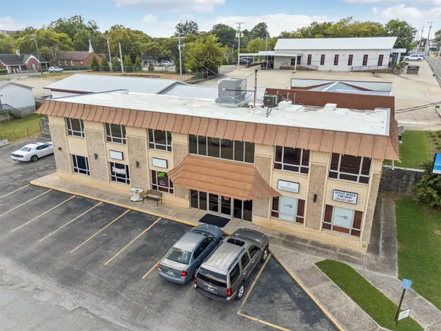 a view of a white building with a ocean view