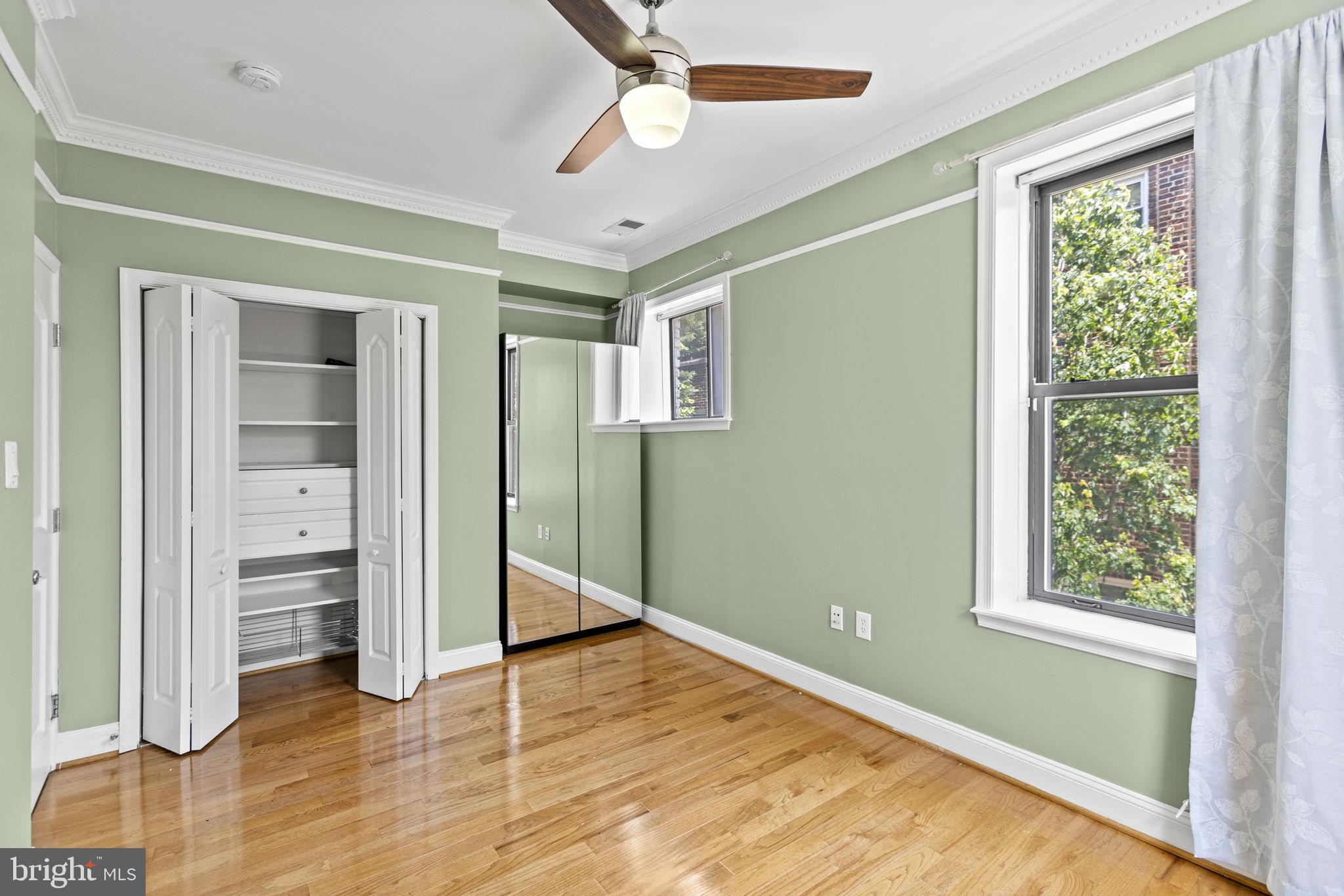 1437 Spring Road Northwest, Unit 21 Washington, DC 20010 - Photo 15 of 25 wooden floor in an empty room with a window