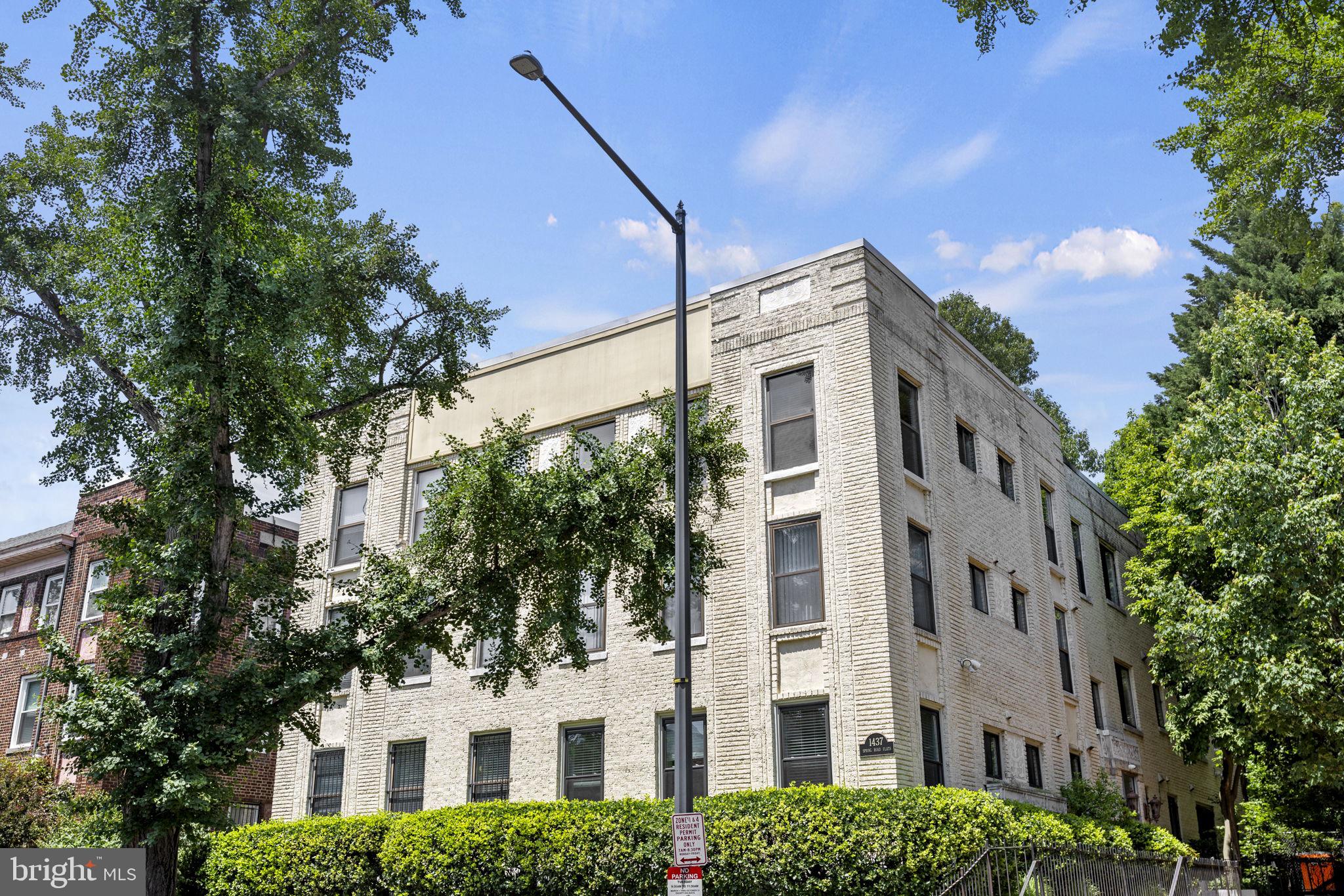 1437 Spring Road Northwest, Unit 21 Washington, DC 20010 - Photo 24 of 25 a view of a building with a tree