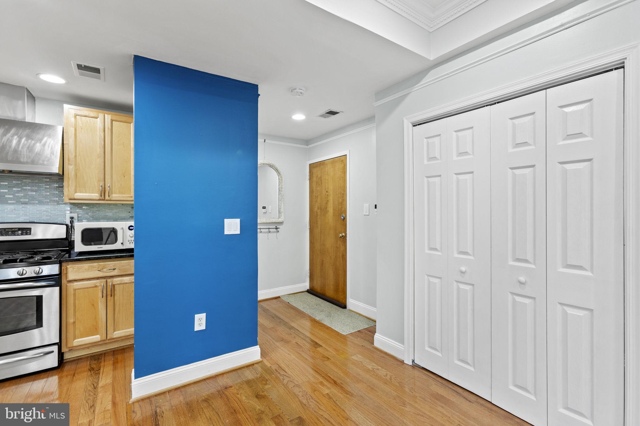 1437 Spring Road Northwest, Unit 21 Washington, DC 20010 - Photo 4 of 25 a view of a kitchen with a sink and a refrigerator