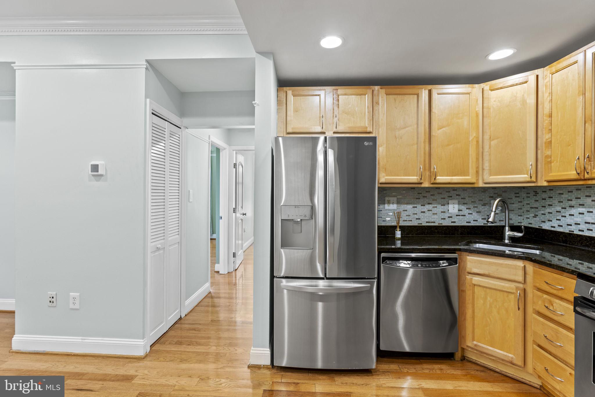 1437 Spring Road Northwest, Unit 21 Washington, DC 20010 - Photo 7 of 25 a kitchen with stainless steel appliances granite countertop a refrigerator sink and cabinets