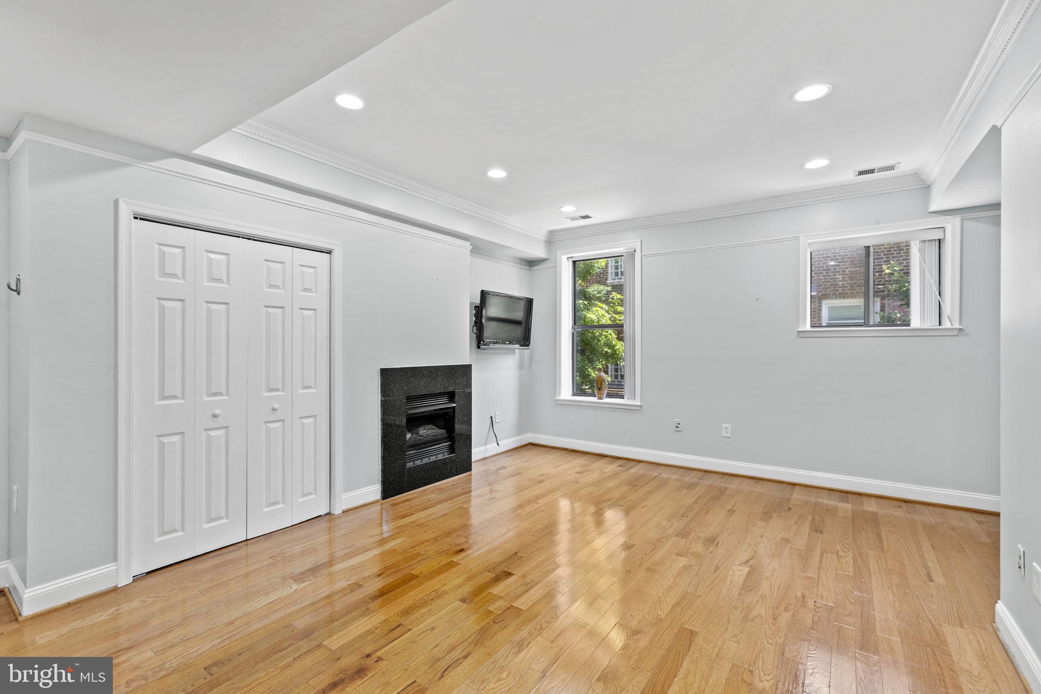 1437 Spring Road Northwest, Unit 21 Washington, DC 20010 - Photo 8 of 25 wooden floor in an empty room with a window