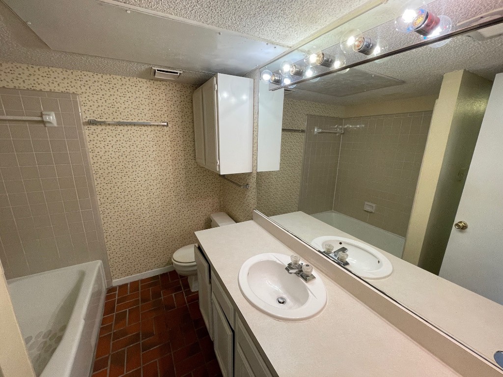 2110 Rio Grande Street, Unit 308 Austin, TX 78705 - Photo 9 of 14 a bathroom with a sink a toilet and shower