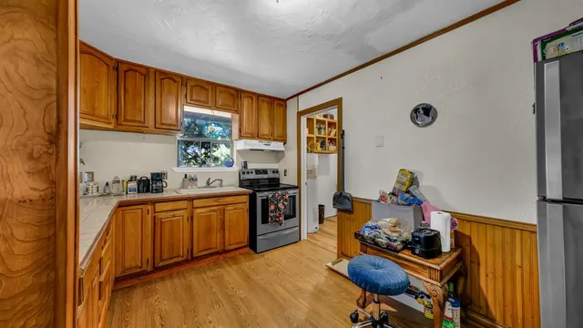 a kitchen with stainless steel appliances granite countertop a refrigerator and a sink