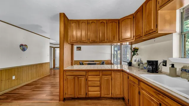a kitchen with stainless steel appliances granite countertop wooden cabinets a sink and dishwasher