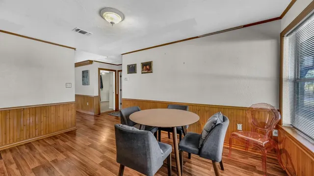 a view of a room with furniture and wooden floor