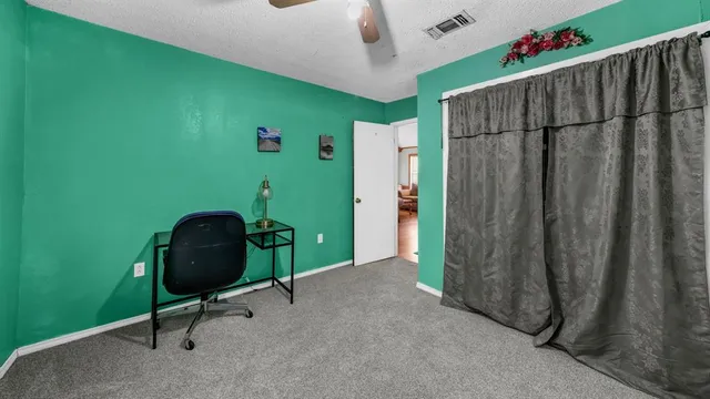 a bedroom with a bed and dresser