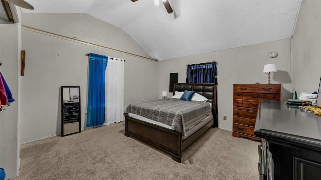 3200 Fairview Road Millsap, TX 76066 - Photo 21 of 33 a bedroom with a bed and dresser