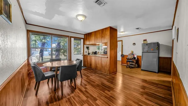 a view of a dining room with furniture window and wooden floor