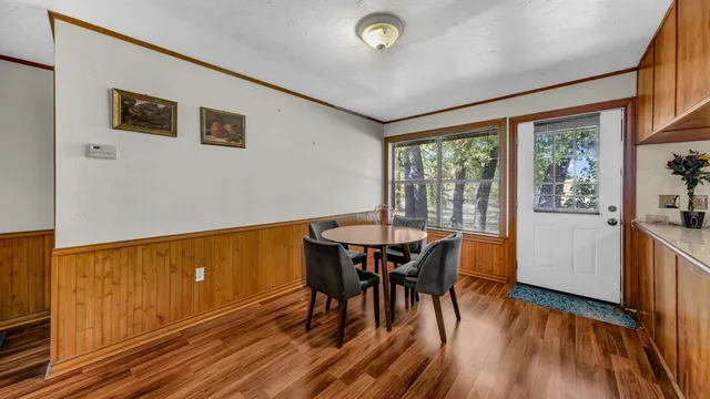 a view of a dining room with furniture window and wooden floor
