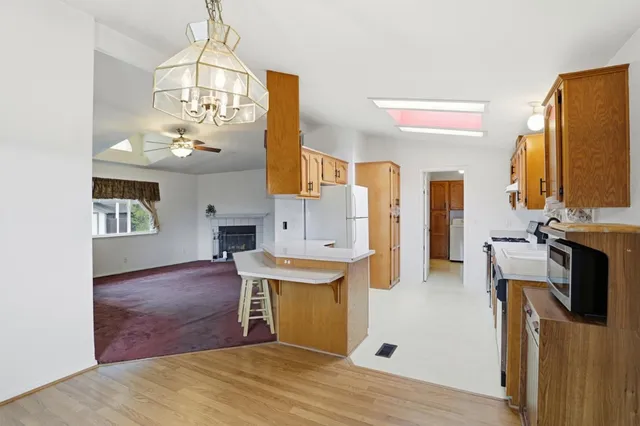 a kitchen with a sink a refrigerator and a stove