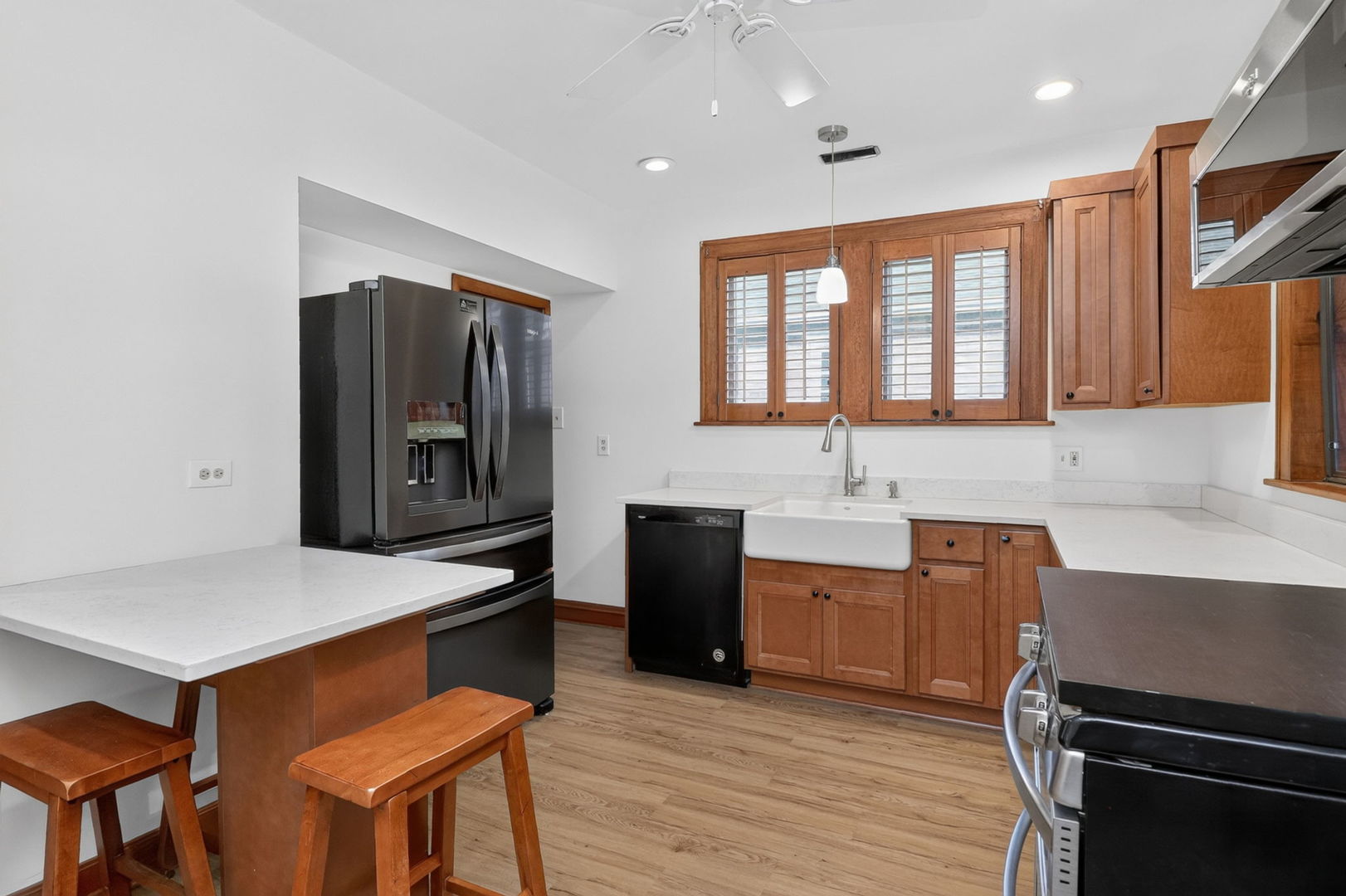 708 McCarthy Road Lemont, IL 60439 - Photo 6 of 14 a kitchen with granite countertop a stove a sink and a refrigerator