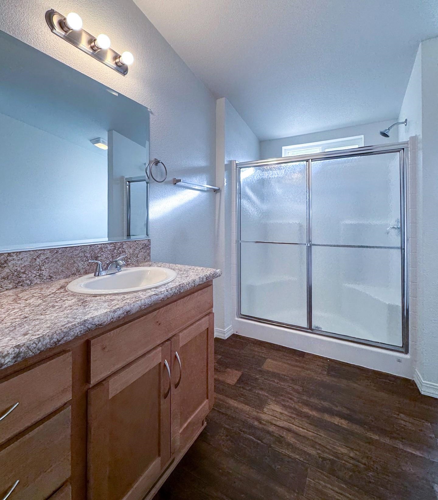 139 Tuolumne Road Bishop, CA 93514 - Photo 11 of 18 a bathroom with a granite countertop sink a toilet and a large mirror