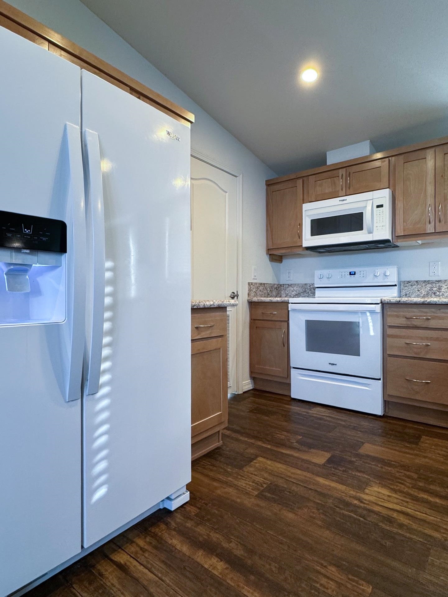 139 Tuolumne Road Bishop, CA 93514 - Photo 4 of 18 a kitchen with stainless steel appliances granite countertop a refrigerator and a stove top oven