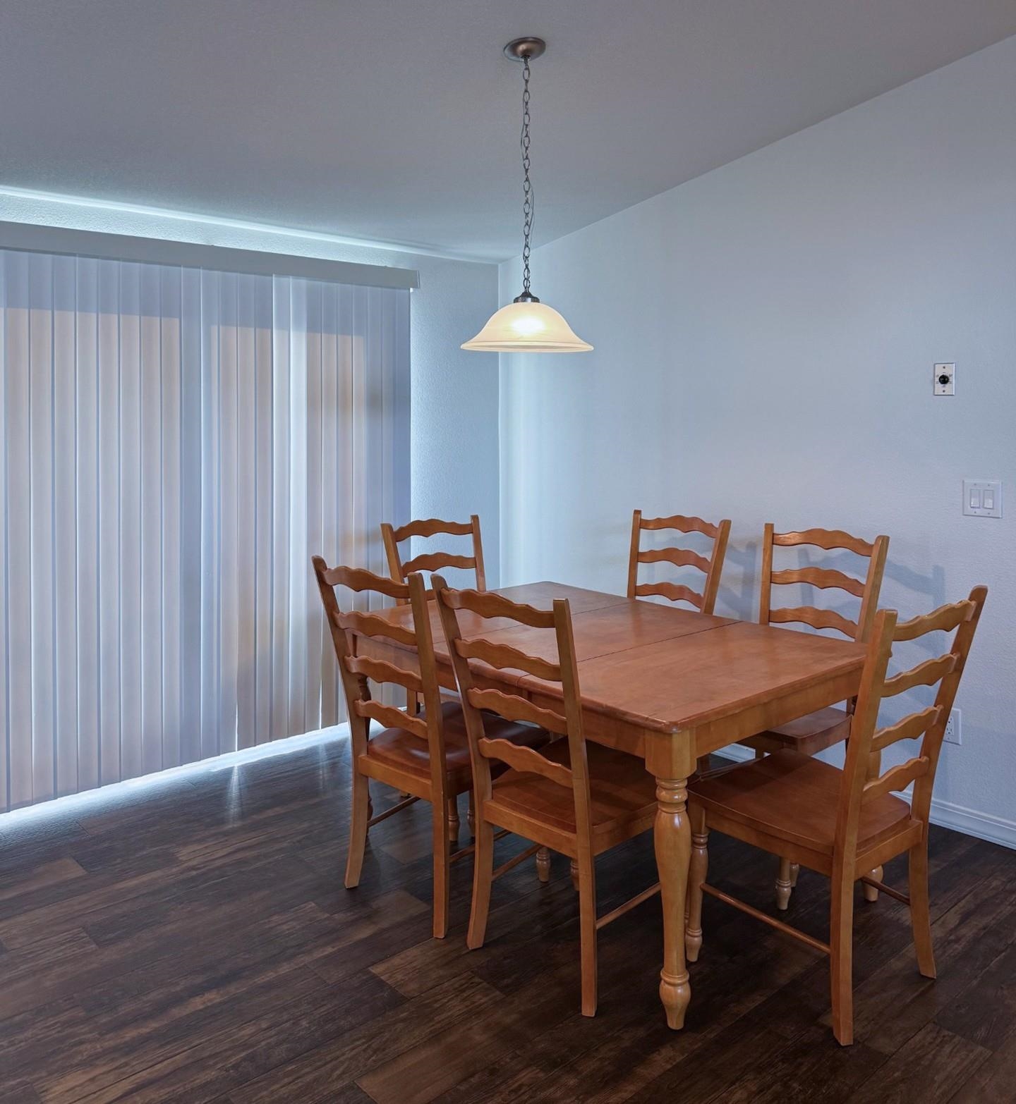 139 Tuolumne Road Bishop, CA 93514 - Photo 5 of 18 a dining room with furniture wooden floor a chandelier