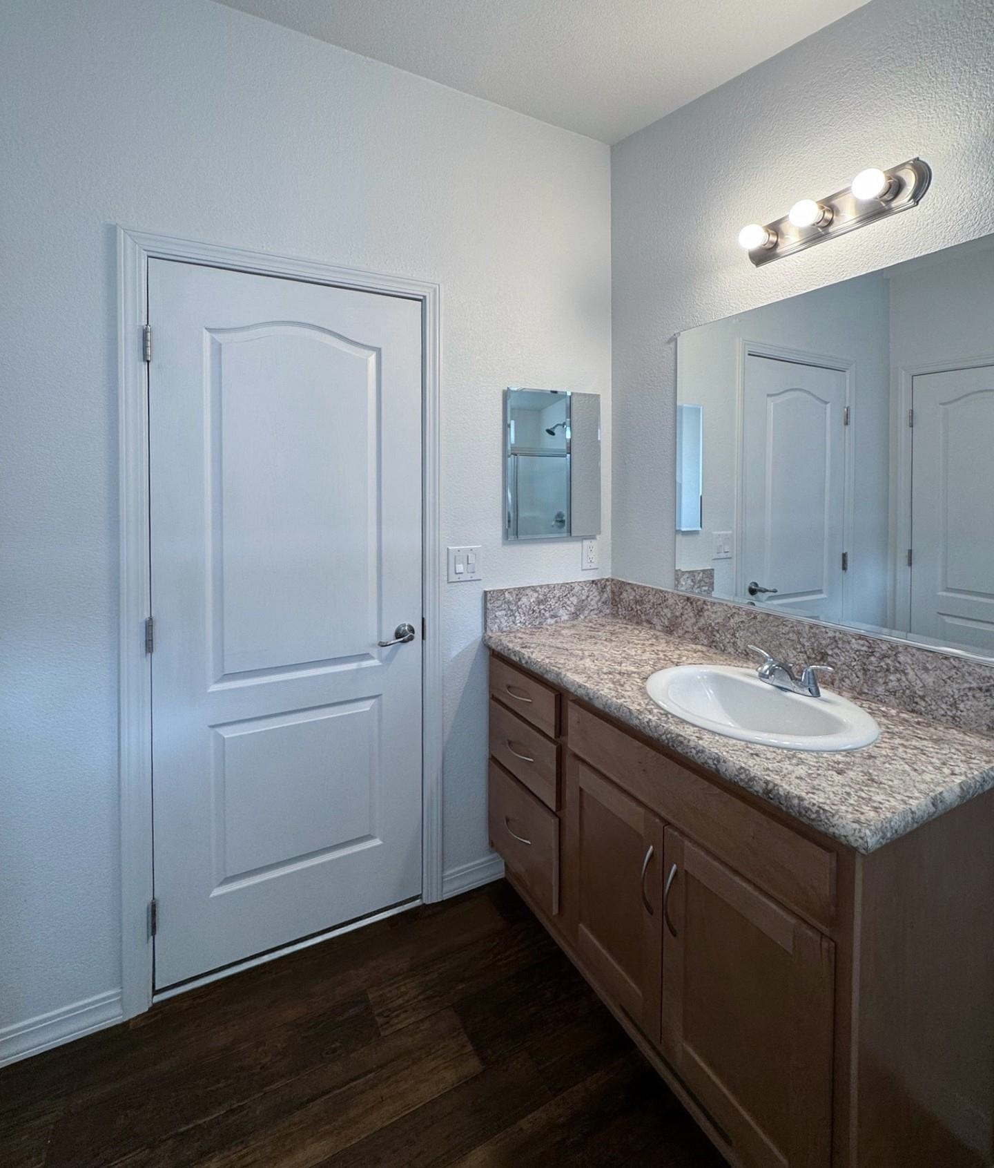 139 Tuolumne Road Bishop, CA 93514 - Photo 8 of 18 a bathroom with a granite countertop sink and a mirror