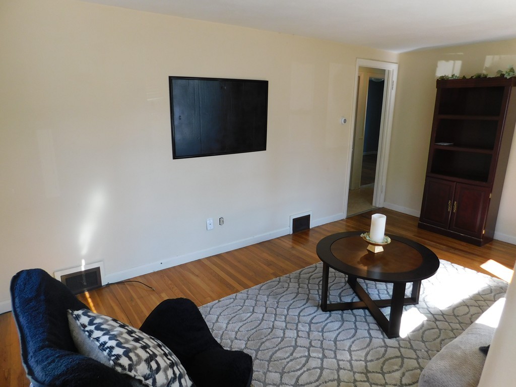 66 Notre Dame Street Springfield, MA 01104 - Photo 13 of 28 a living room with furniture and a lamp